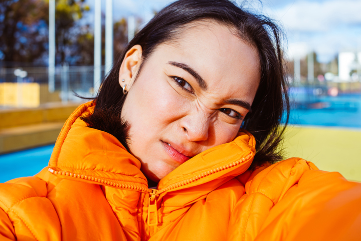 Anxious looking woman taking a selfie.