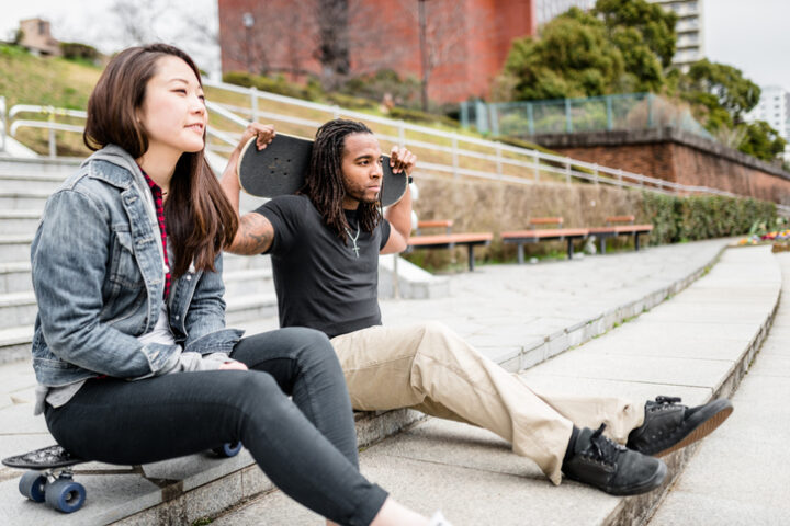 skateboarding couple sitting on steps