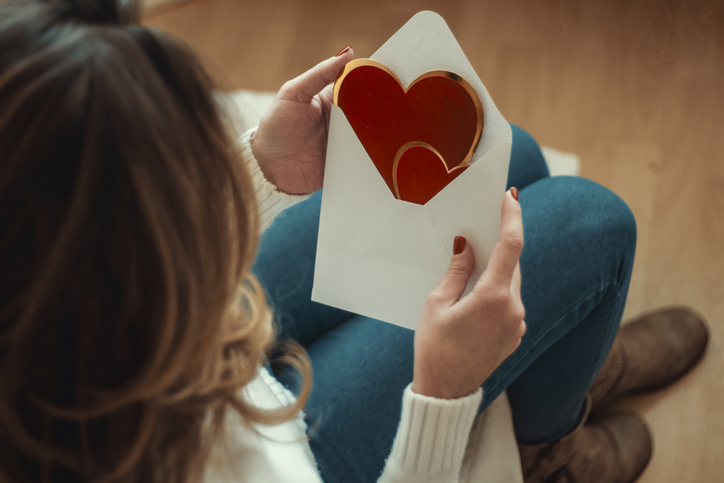 Woman reading a card.