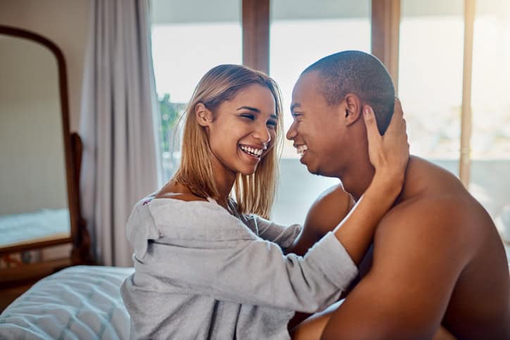 Couple sharing a moment in bed.