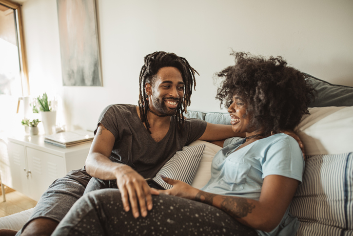 Couple chatting on the couch.