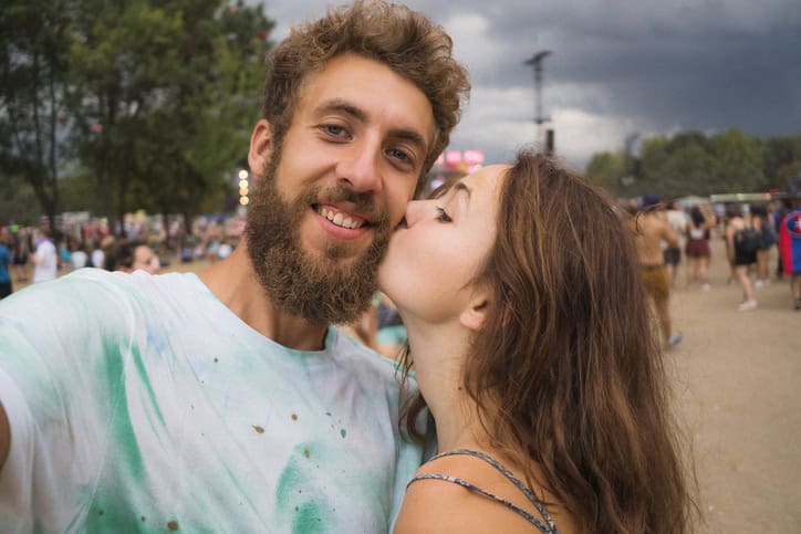 woman kissing boyfriend on cheek
