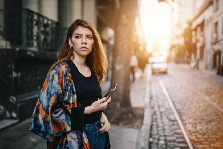 woman with cellphone on city streets