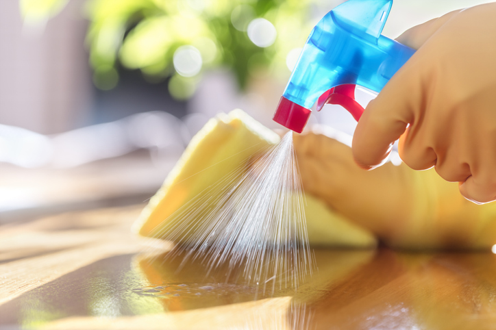 Cleaning counter with spray cleaner.