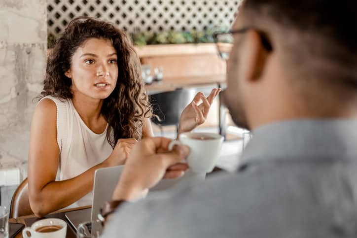 woman questioning her boyfriend over lunch