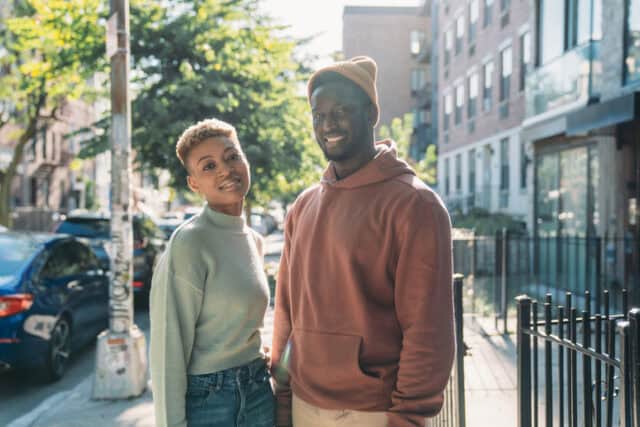 trendy couple standing on city street
