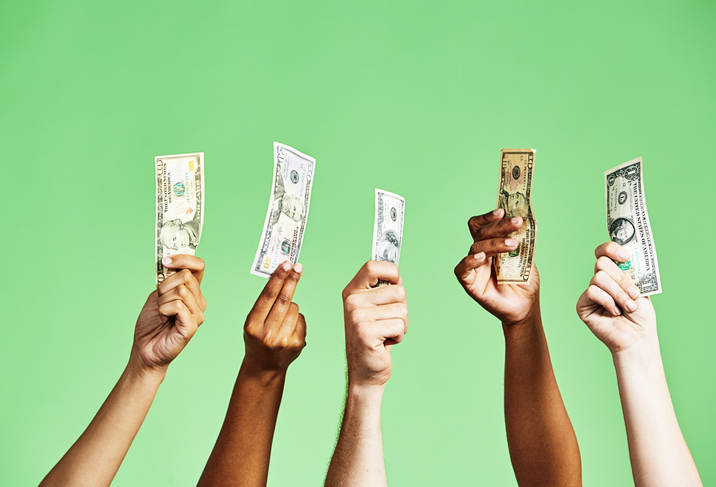 Multiple hands holding money.
