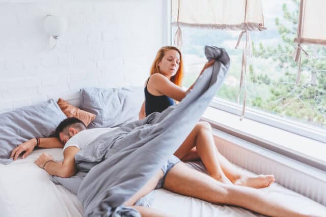 angry woman pulling sheets bed