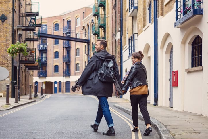 happy couple walking through city