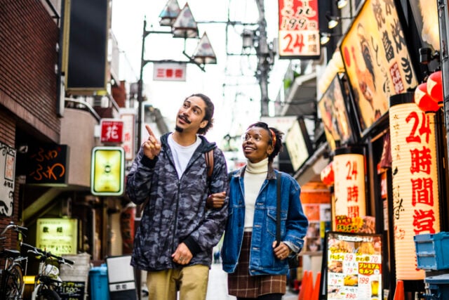 young couple walking through chinatown