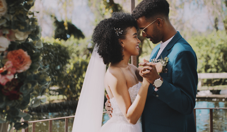 Romantic couple kissing at their wedding.