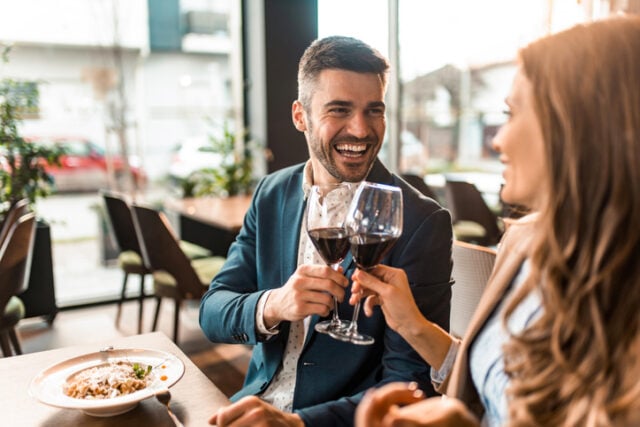 couple clinking wine glasses date