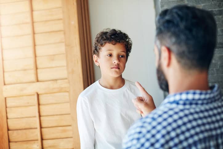 dad disciplining young son
