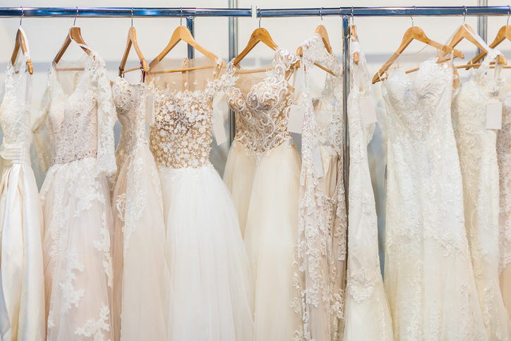 Wedding dresses on store rack.