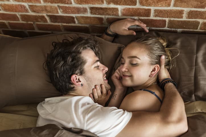 couple cuddling in bed together
