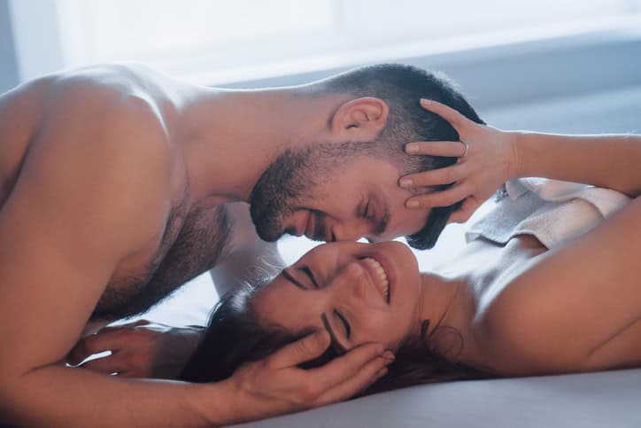 couple getting intimate in bed