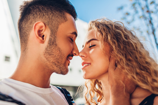 Couple touches noses.