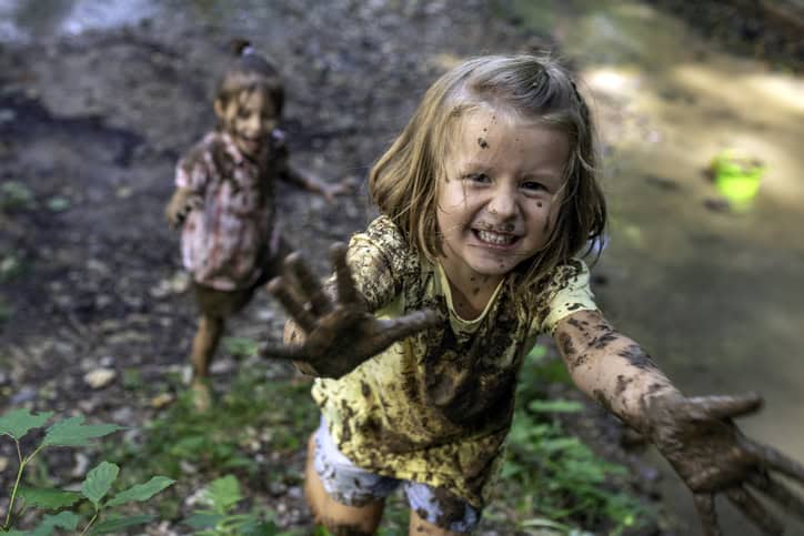 Smiling little muddy girl.