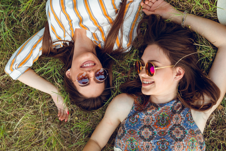 Happy friends laying on the grass.