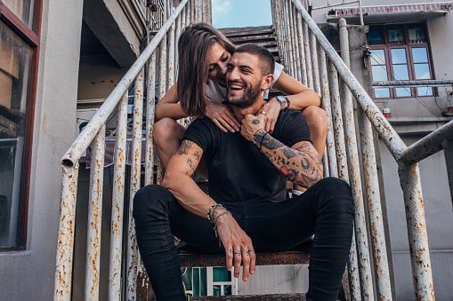 Couple sitting on stairs.