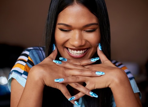 Young woman showing off her beautiful nails.