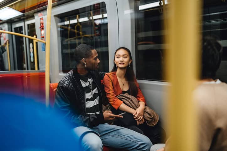 mixed race couple flirting on subway