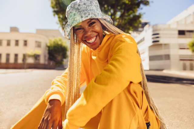 smiling black woman sitting outdoors