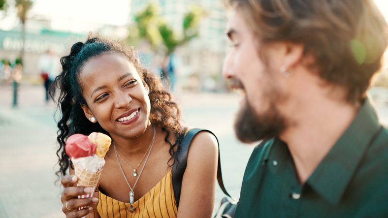 Smiling couple on an ice cream date.