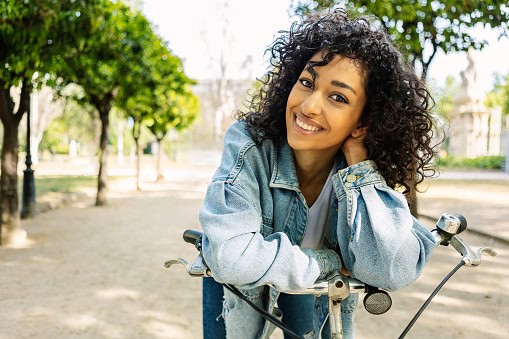 smiling woman outdoor with bike