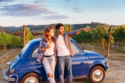 A couple watch the sunset in Italy.