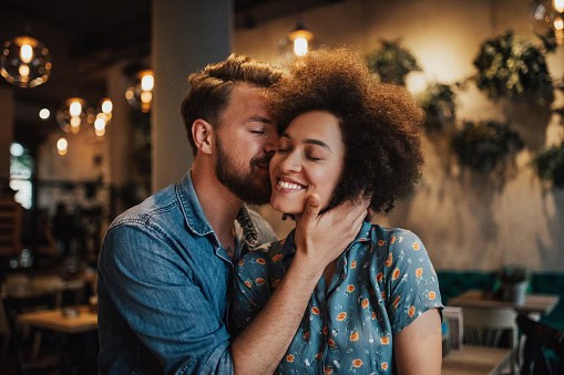 Man kissing his wife.