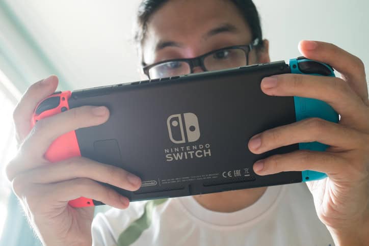 man playing nintendo switch