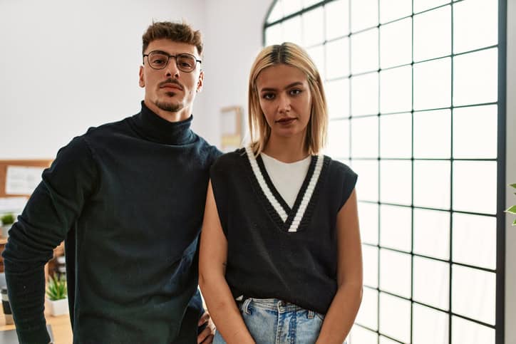 serious unhappy hipster couple at home