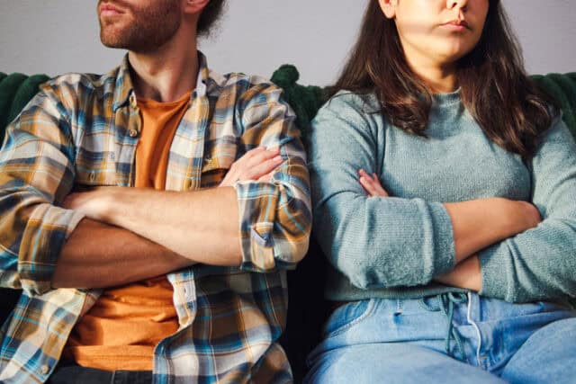 couple arguing crossed arms couch