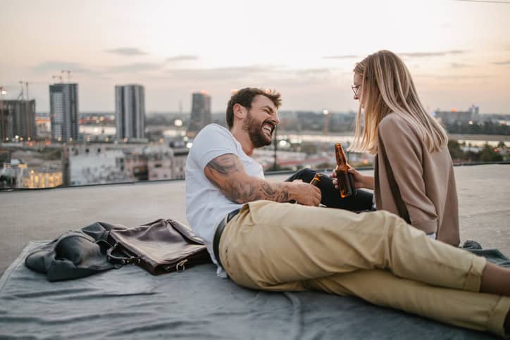 couple sitting by river on date