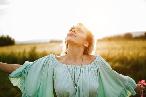 Woman making time for healing beauty of nature.