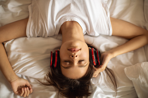 Woman enjoying music on her headphones.