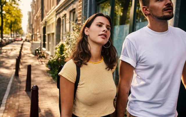 couple walking hand in hand down the street