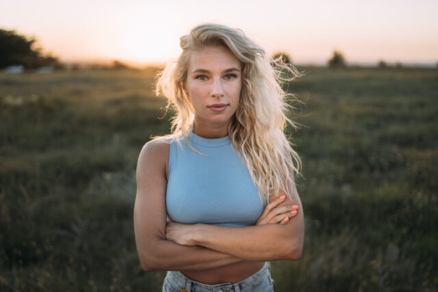 serious blonde woman outdoors at sunset