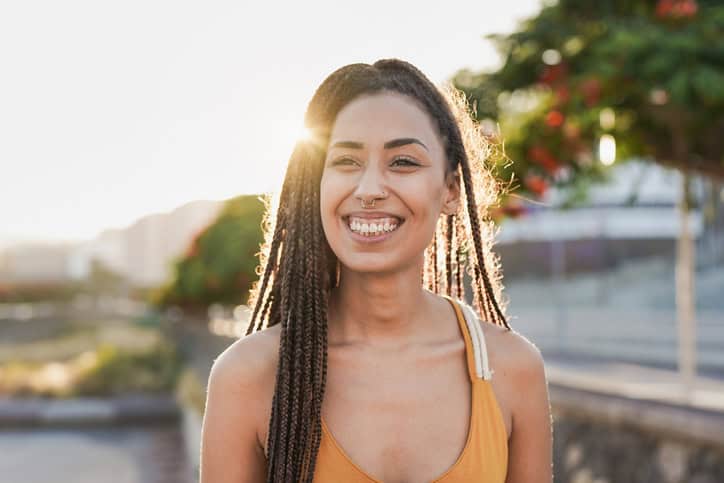 beautiful smiling woman outdoors in sunset