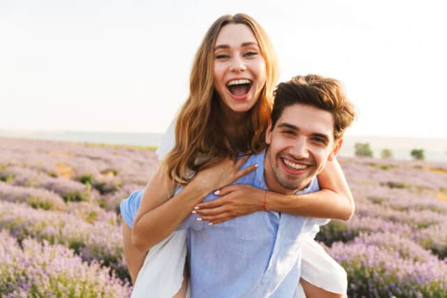 happy couple embracing on sunny beach