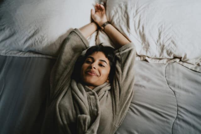 happy woman having good dream in bed