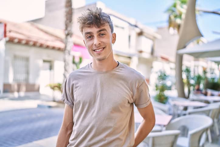 smiling millennial man on sunny day