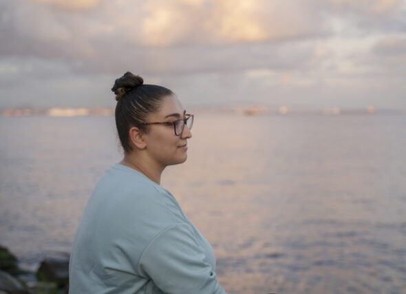 thoughtful woman looking out over water