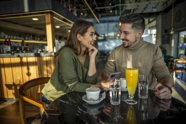 couple having fun conversation at bar date