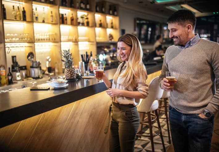 guy checking out woman at bar