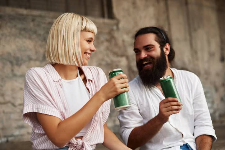 Friends drinking from a can.