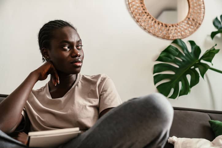 woman on couch looking out window