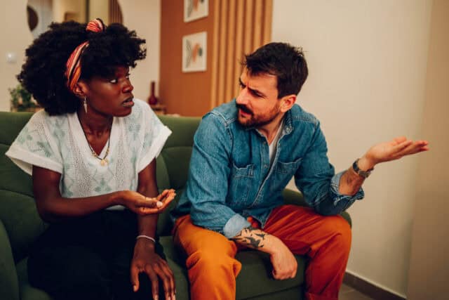 couple in an argument on the couch