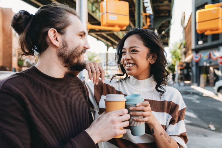 happy couple drinking coffee NYC streets